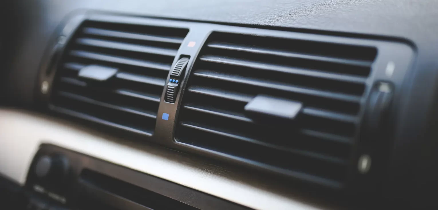 A close up on a car's air conditioner vents