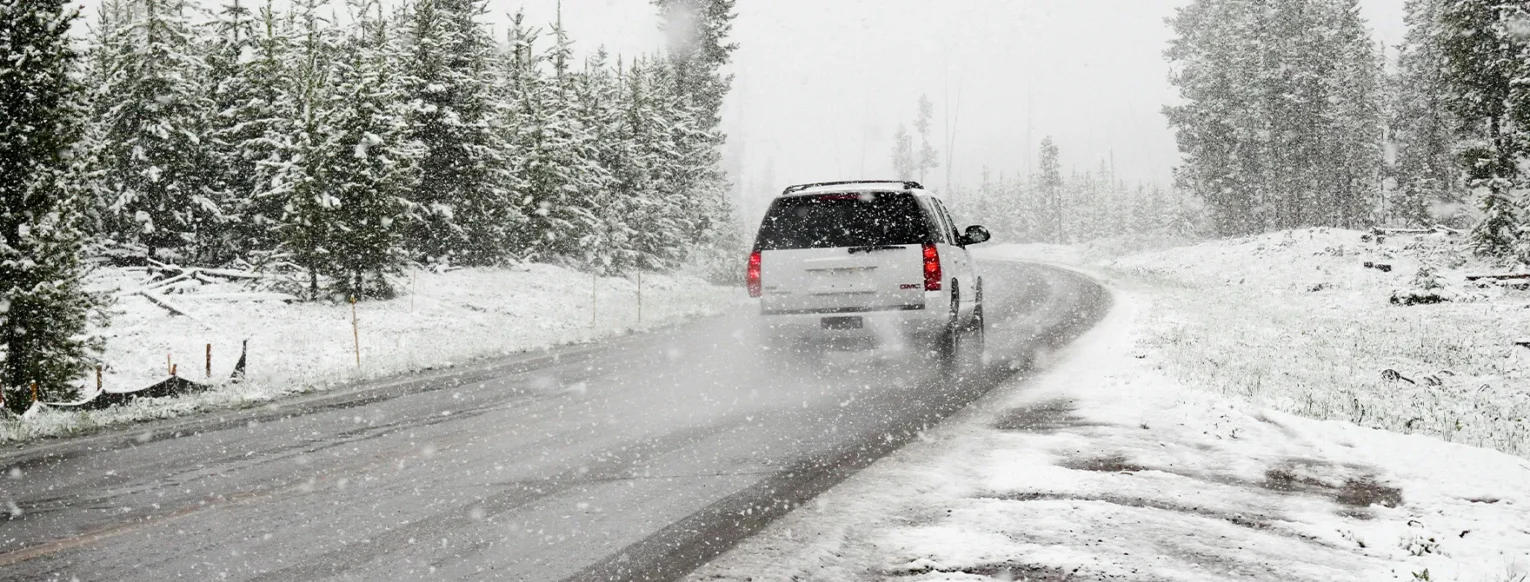 A car driving on a snowy road